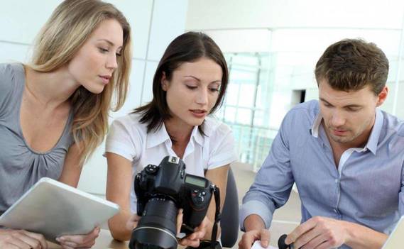 Normal_man-and-women-with-cameras-and-tablet-looking-at-documents