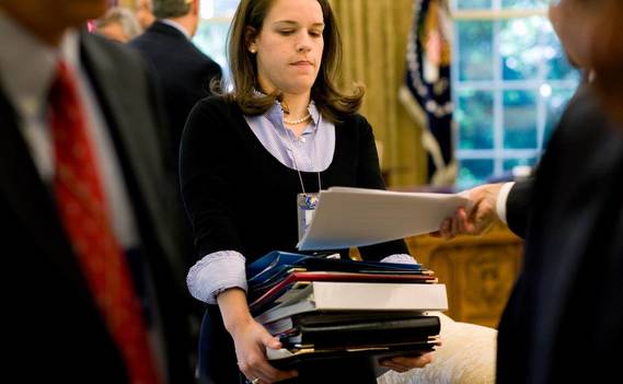 Normal_personal_secretary_carrying_a_stack_of_documents_o